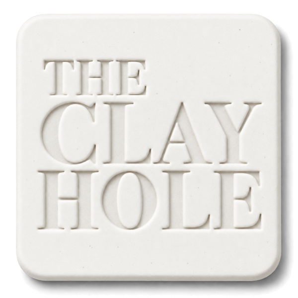 White Laguna #16 Porcelain cone 6 clay tile, unglazed, stamped with The Clay Hole logo