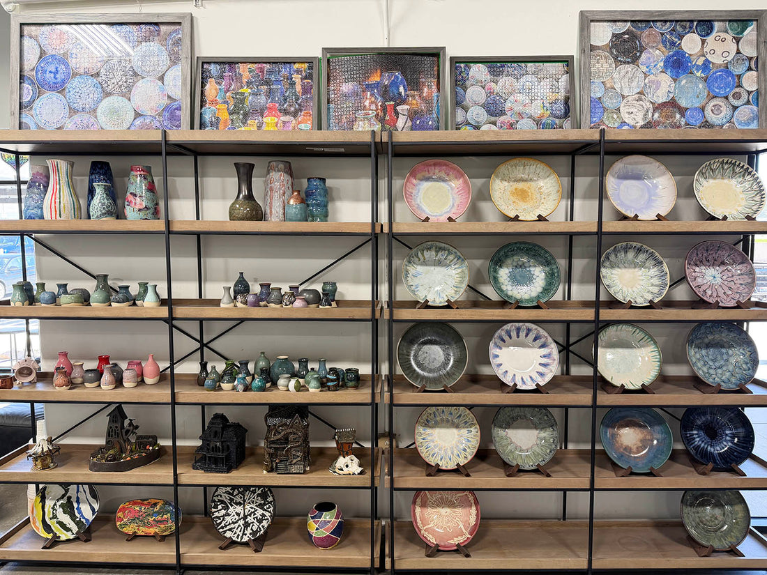 Finished pottery displayed on shelves throughout the studio.