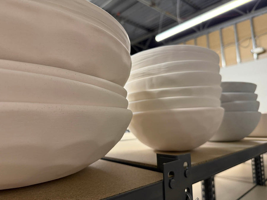 Bisque fired bowls stacked and nested to save shelf space