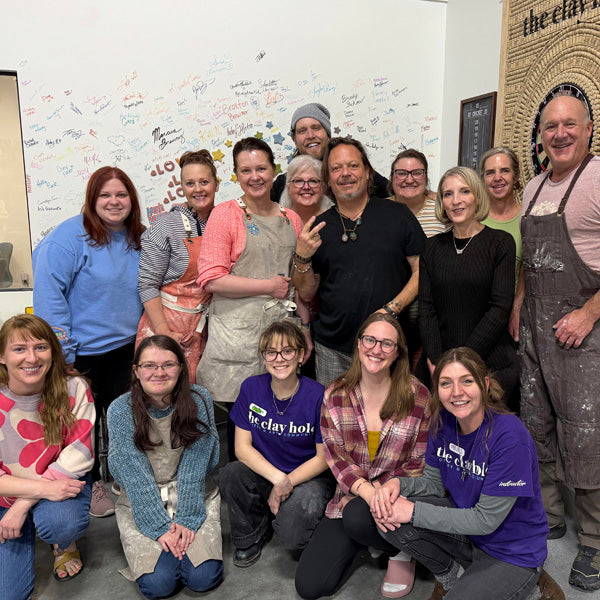 A large group of Clay Hole members posed together after a class