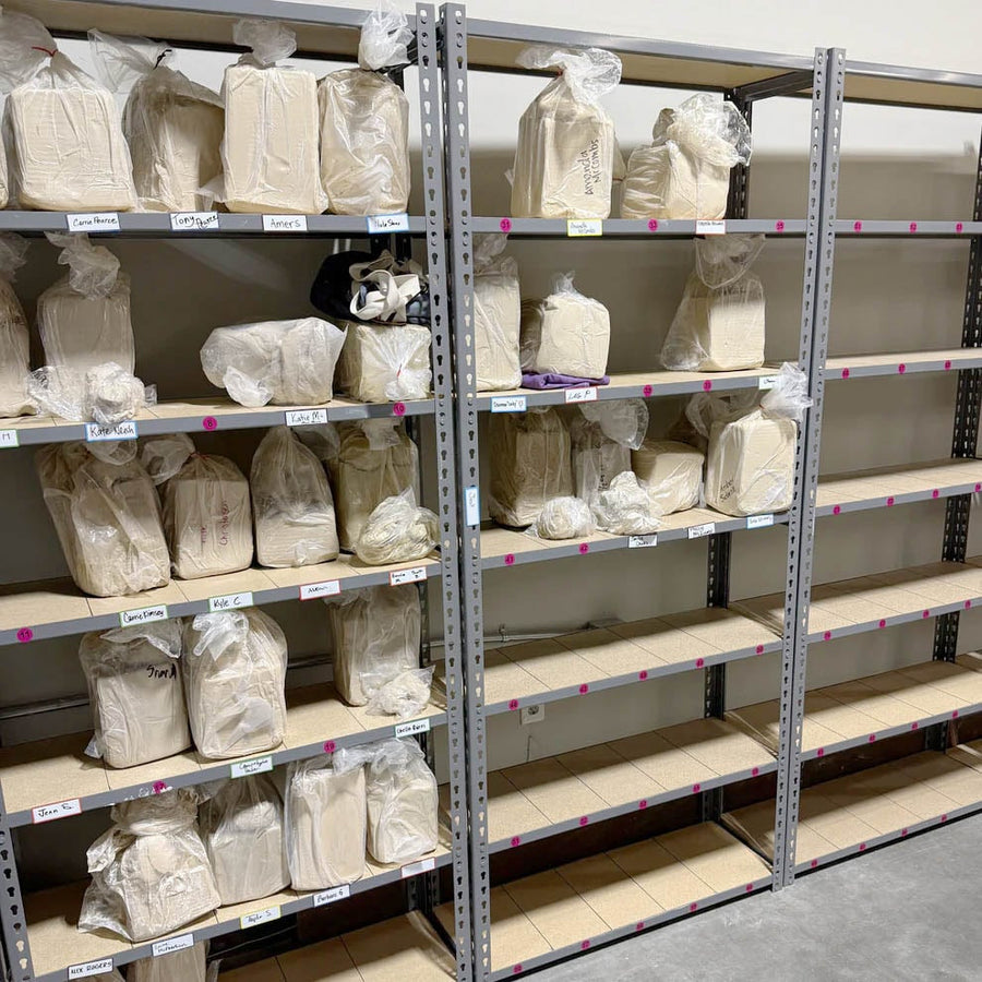 The clay cubby wall at The Clay Hole with bags of clay stored inside
