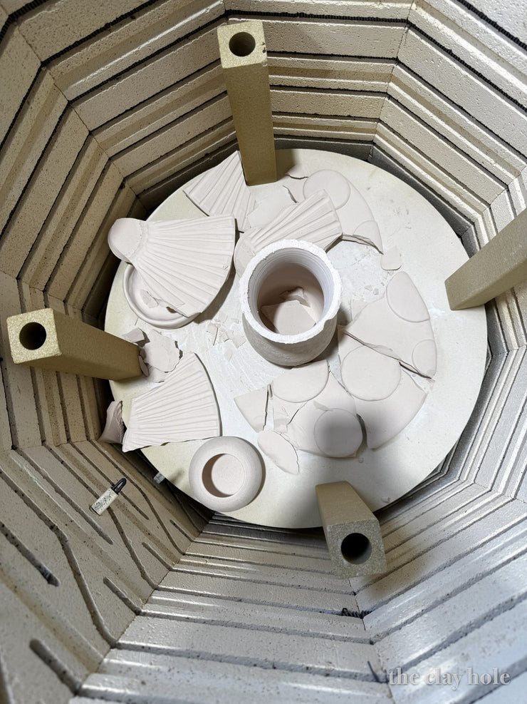 Looking down into a kiln at pottery that exploded during the firing