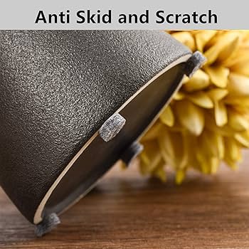 Dark felt bumper pads on the rim of a black bowl resting on a wooden table