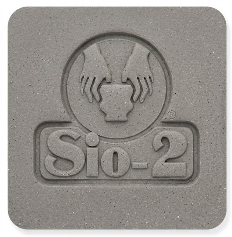A fired, unglazed Berlin Gray tile with the Sio-2 maker's mark pressed into it, showing the cement gray color and fine speckle