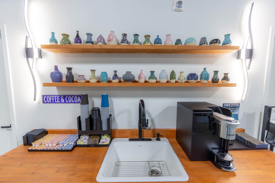 A hot drinks station with coffee and cocoa supplies.