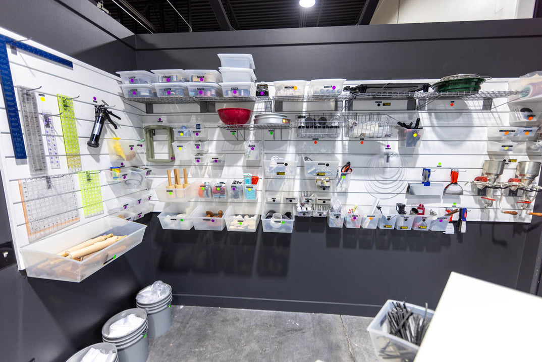 Organized bins and drawers of specialist ceramics tools.