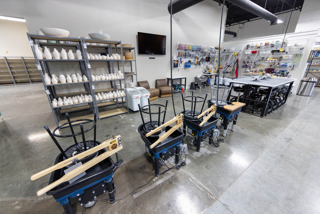An open work area where studio staff make their own pottery in view of members.