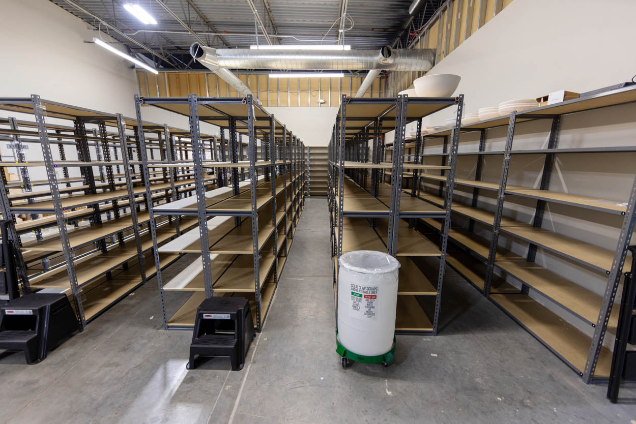 Rows of member shelving stacked with work in progress.