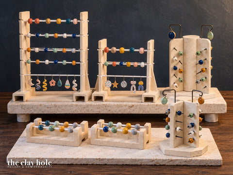 Kiln bead racks, a jewelry rack and a bead tree made from The Clay Hole kiln furniture paper templates, on kiln shelves