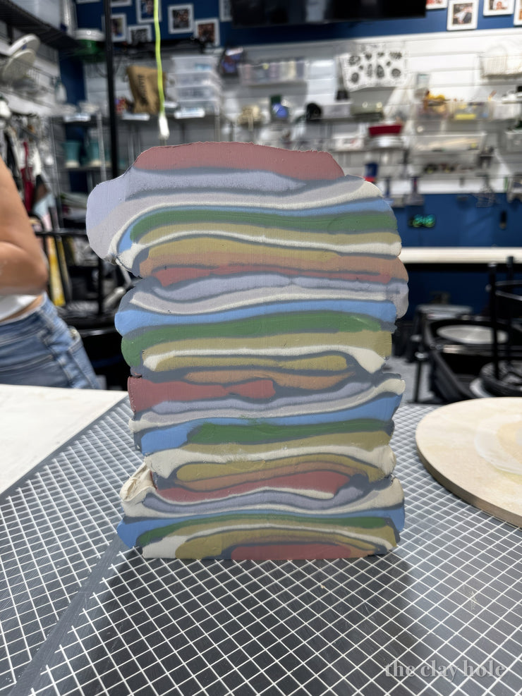 Tall block of layered colored porcelain stacked for nerikomi pottery bowls and platters