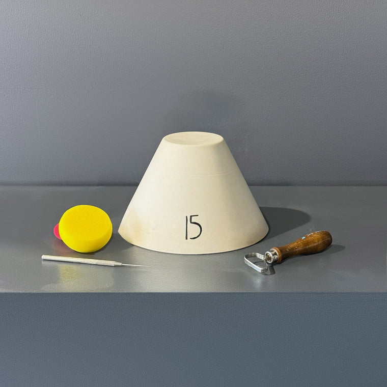 White pottery plaster mold number 15: a tall round truncated cone, flaring out toward the bottom with an open recess at the top.