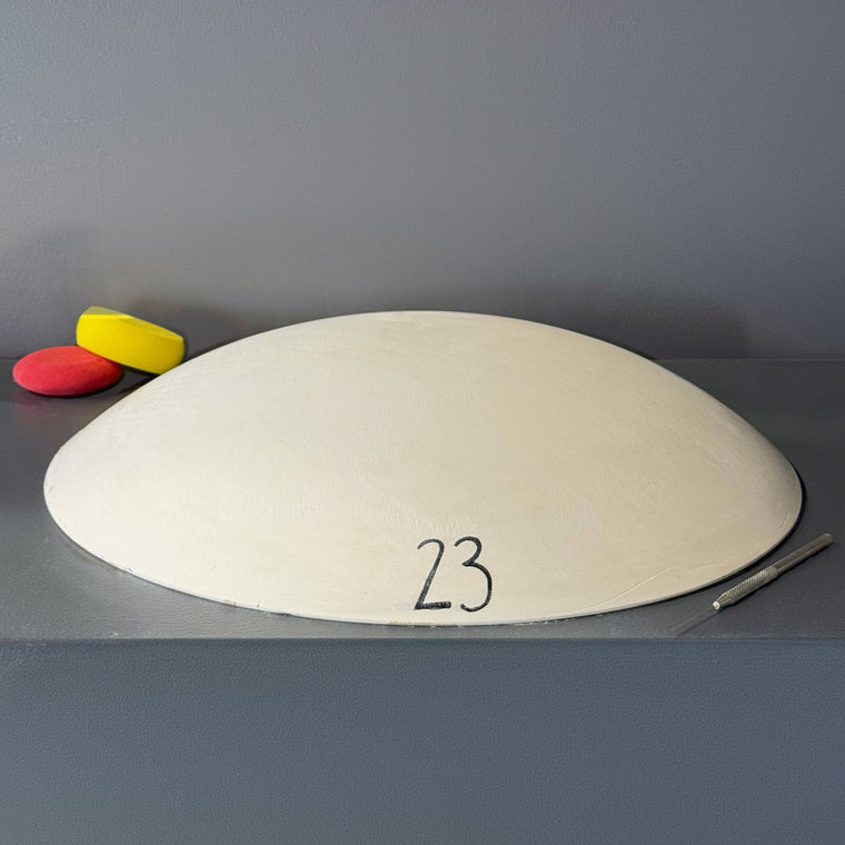 White pottery plaster hump mold number 23: a large pointed-oval platter mold, tapering to a point at each end.