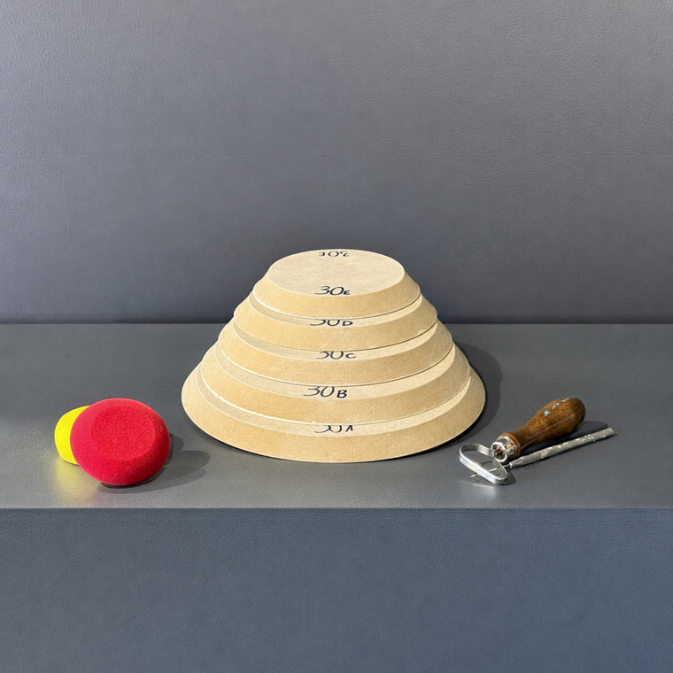 High-density fiberboard mold 30A: a flat round disc with a chamfered edge, the largest of a 5-piece nesting set shown stacked largest to smallest on the gray shelf, hand-labeled 30A.