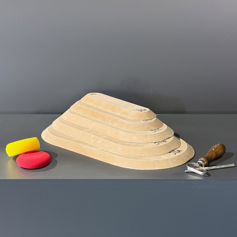 High-density fiberboard mold 31A: a rounded rectangular board, the largest of a 5-piece nesting set shown stacked largest to smallest on the gray shelf, hand-labeled 31A.