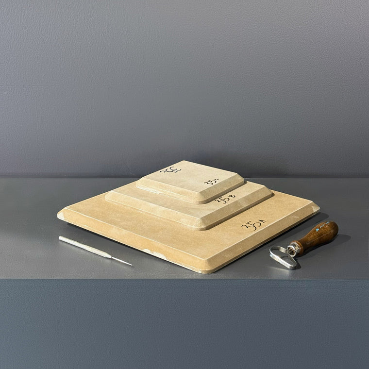 High-density fiberboard mold 35A: a square board with softened corners, the largest of a 3-piece nesting set shown stacked largest to smallest on the gray shelf, hand-labeled 35A.