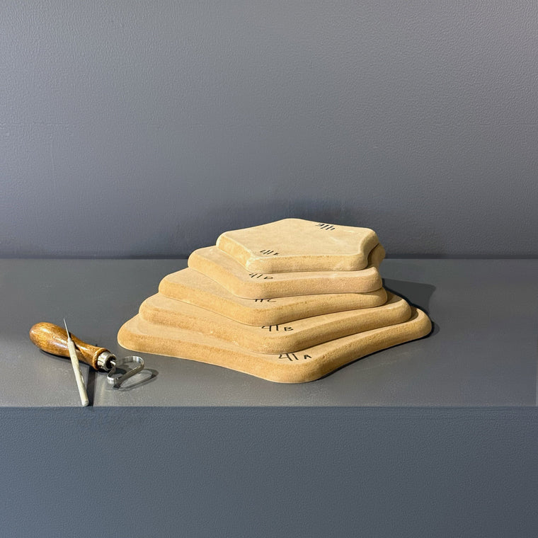 High-density fiberboard mold 41A: a softly squared organic board, the largest of a 5-piece nesting set shown stacked largest to smallest on the gray shelf, hand-labeled 41A.