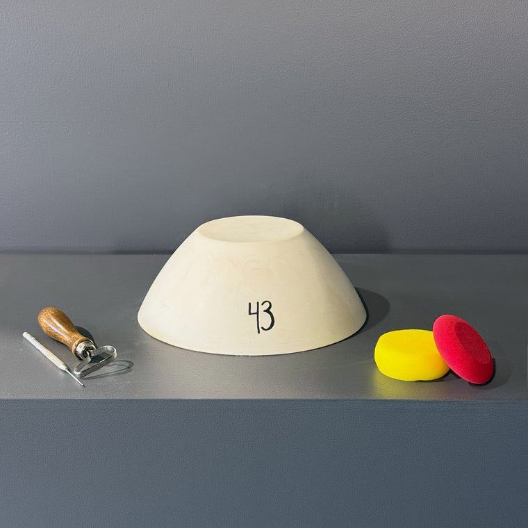 White pottery plaster mold number 43: a round truncated cone, measuring 9.9 in wide, 9.9 in deep and 4.3 in tall with an open recessed top.