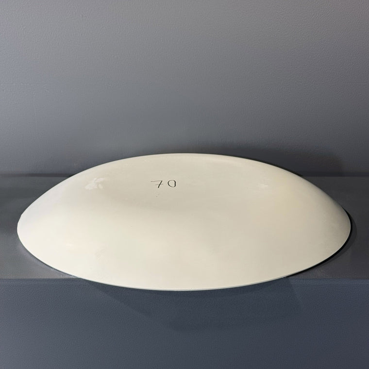 White pottery plaster hump mold number 70: a very large, low lens-shaped oval dome, sitting close to the front of the gray shelf.