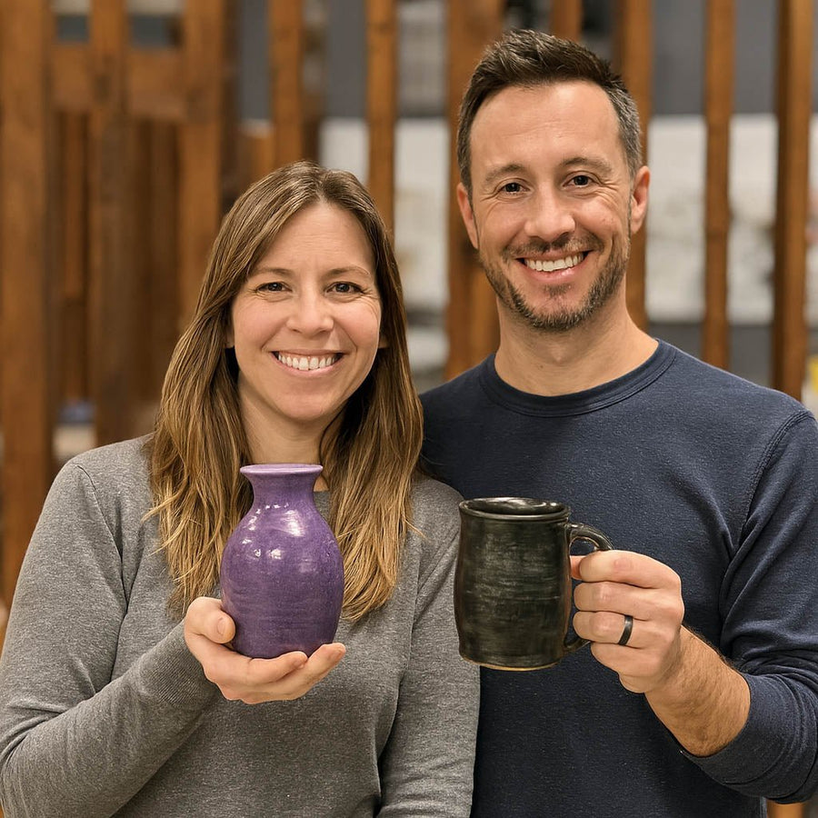 Two Clay Hole members holding the pots they each made, a purple vase and a dark mug