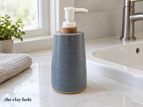A Soap Pump Bottle made from The Clay Hole paper template 36: a tapered soap bottle from one fan-shaped wall, with a hole sized for a cork pump