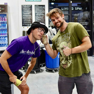 Two people pose playfully in the studio, one in a bucket hat and the other giving a thumbs up at The Clay Hole in Draper, Utah