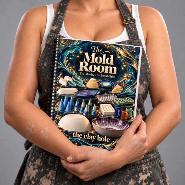 A Clay Hole member in a clay splattered apron holding the spiral bound printed Mold Room guide against her chest