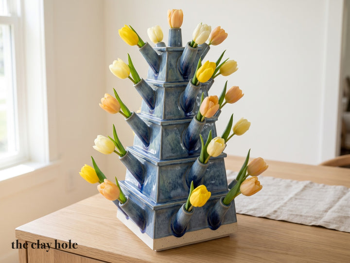 A five-tier blue stoneware tulip pagoda with 25 spouts and a tulip in each, made from The Clay Hole paper template